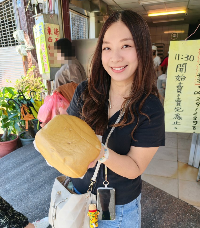 手持大城黑糖饅頭與開賣告示牌合照，展現超大份量